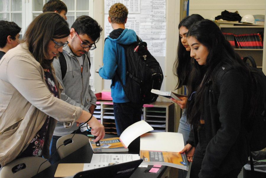 Media specialist Elizabeth Snow checks out books to incoming International
Baccalaureate Environmental Systems and Societies students.
